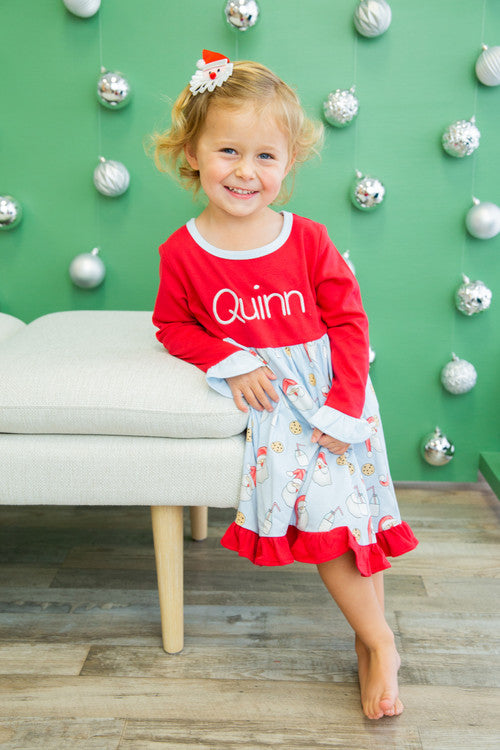 Girl wearing red long sleeve holiday dress with Cookies for Santa print